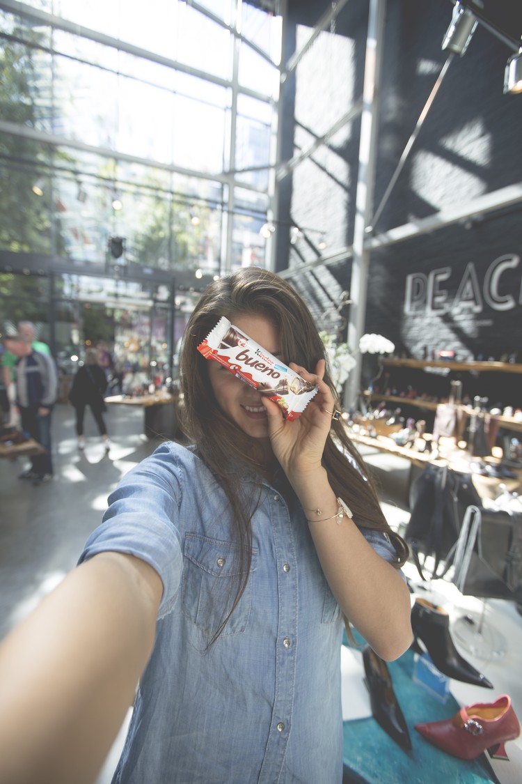 Girl with Kinder Bueno shops at John Fluevog in Vancouver