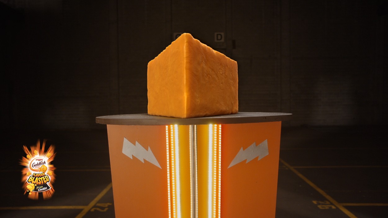Huge block of cheddar cheese on top of strength tester