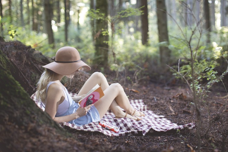 Girl in forest, having a picnic