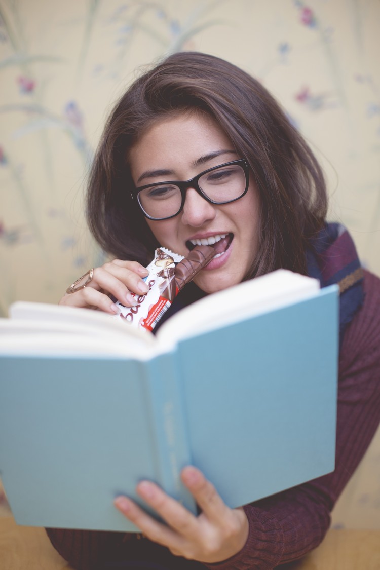 Girl in coffee shop with Kinder Bueno
