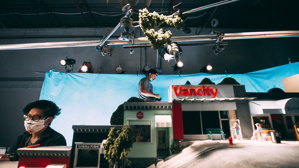 Miniature storefronts in a studio with filmmakers