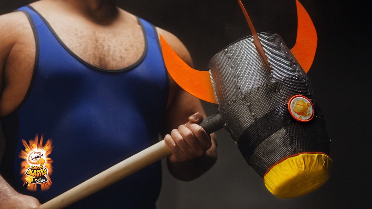 Strongman holding Rocket-Powered Hammer Goldfish Crackers Flavour Blasted XTreme Cheddar